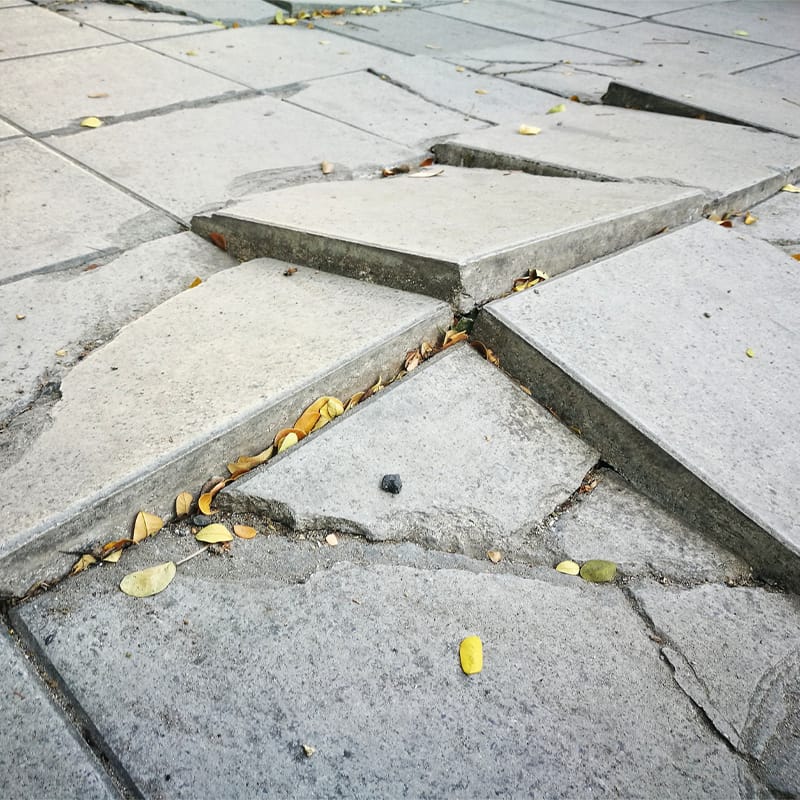 cracked uneven sidewalk
